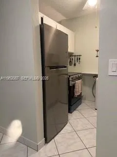 a kitchen with a refrigerator and a sink