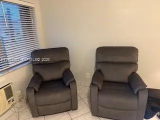 a living room with furniture and a chair
