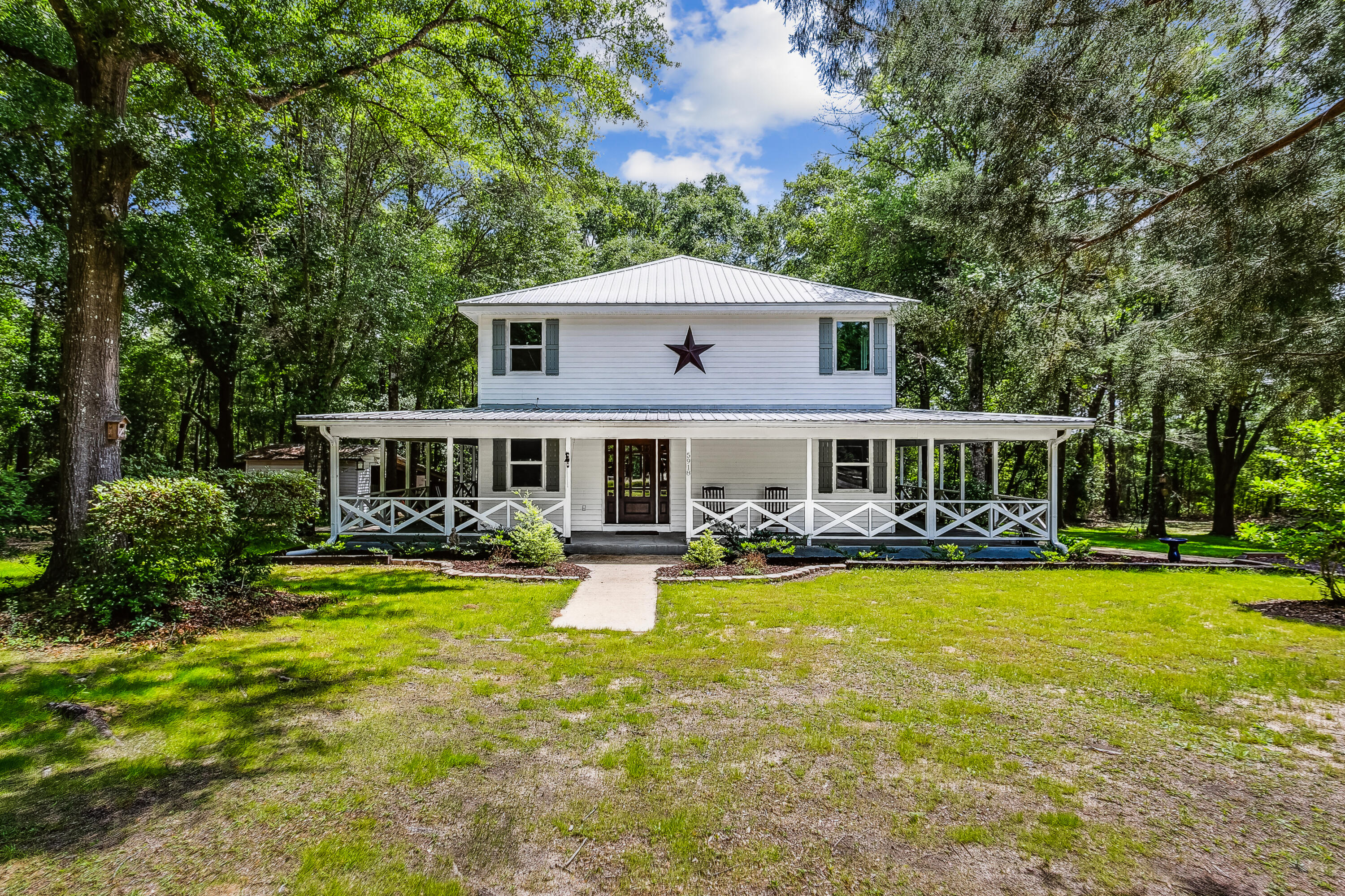 a front view of a house with swimming pool having outdoor seating
