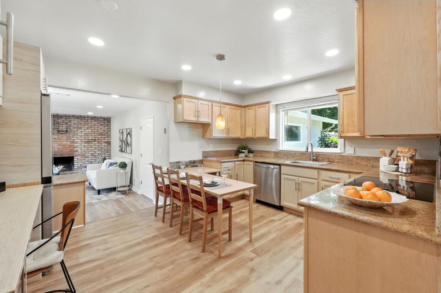 479 Chestnut Avenue Milpitas, CA 95035 - Photo 11 of 27 a kitchen with a sink a counter top space a large window and stainless steel appliances