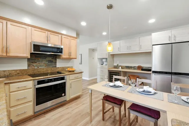 a kitchen with a sink stove and cabinets