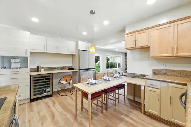 a living room with furniture a fireplace and a floor to ceiling window