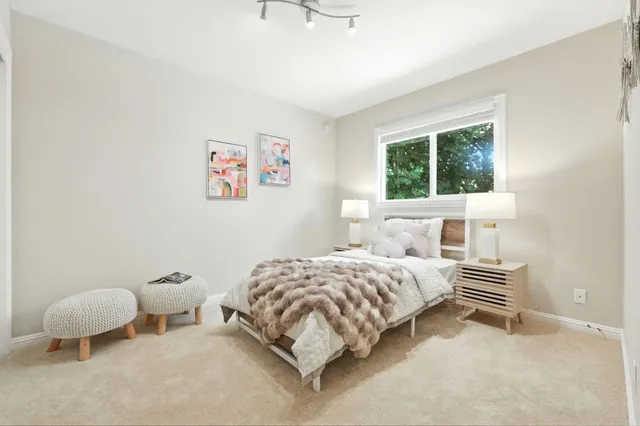 a bedroom with a bed and a window