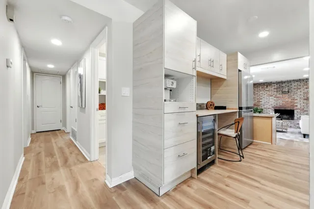 a kitchen with a sink a counter top space a large window and stainless steel appliances