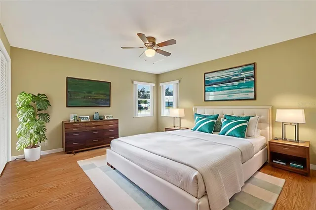 a bedroom with a large bed and a chandelier