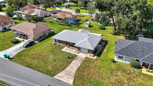 an aerial view of a house with garden space and street view