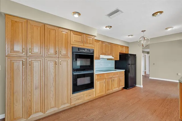 a large white kitchen with a large window