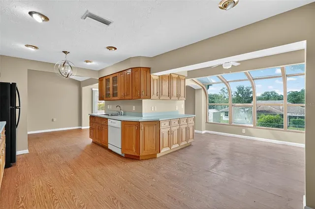 a kitchen with granite countertop a sink and a wooden cabinets
