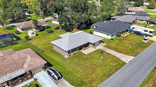 an aerial view of a house with garden space and street view