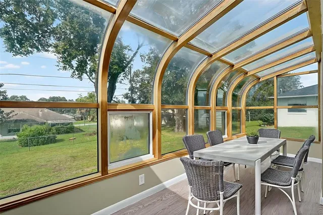 a view of a house with a big yard and large trees