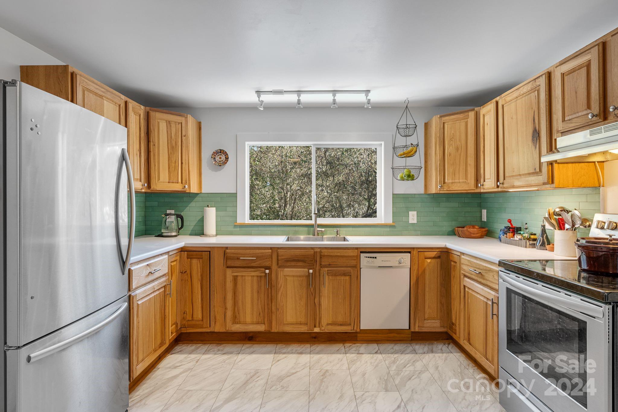 608 Barnard Road Marshall, NC 28753 - Photo 7 of 23 a kitchen with a refrigerator a sink and a window
