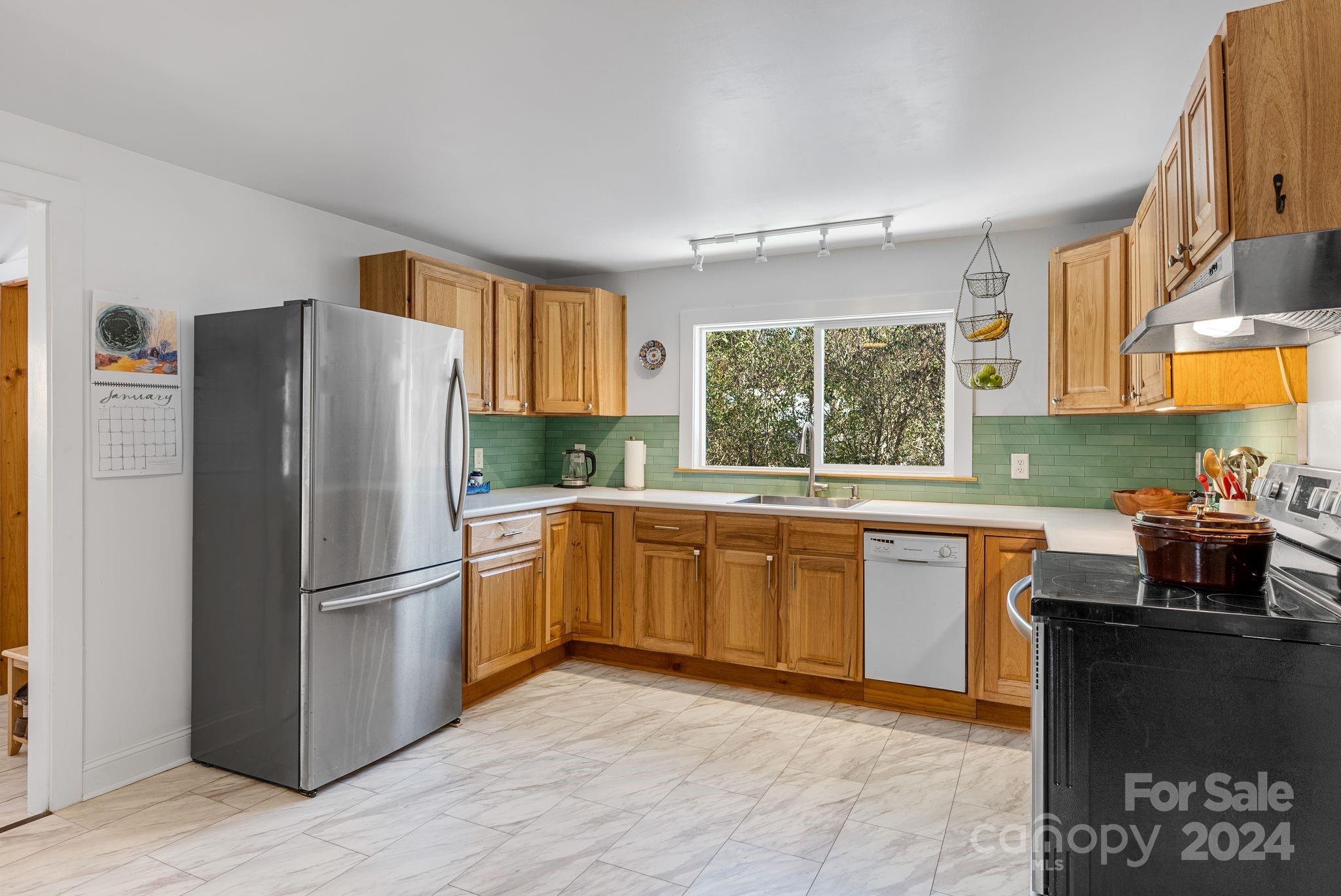 608 Barnard Road Marshall, NC 28753 - Photo 8 of 23 a kitchen with granite countertop a refrigerator stove top oven and sink
