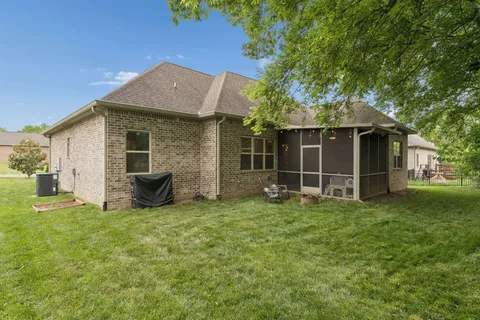 a view of a house with backyard porch and garden
