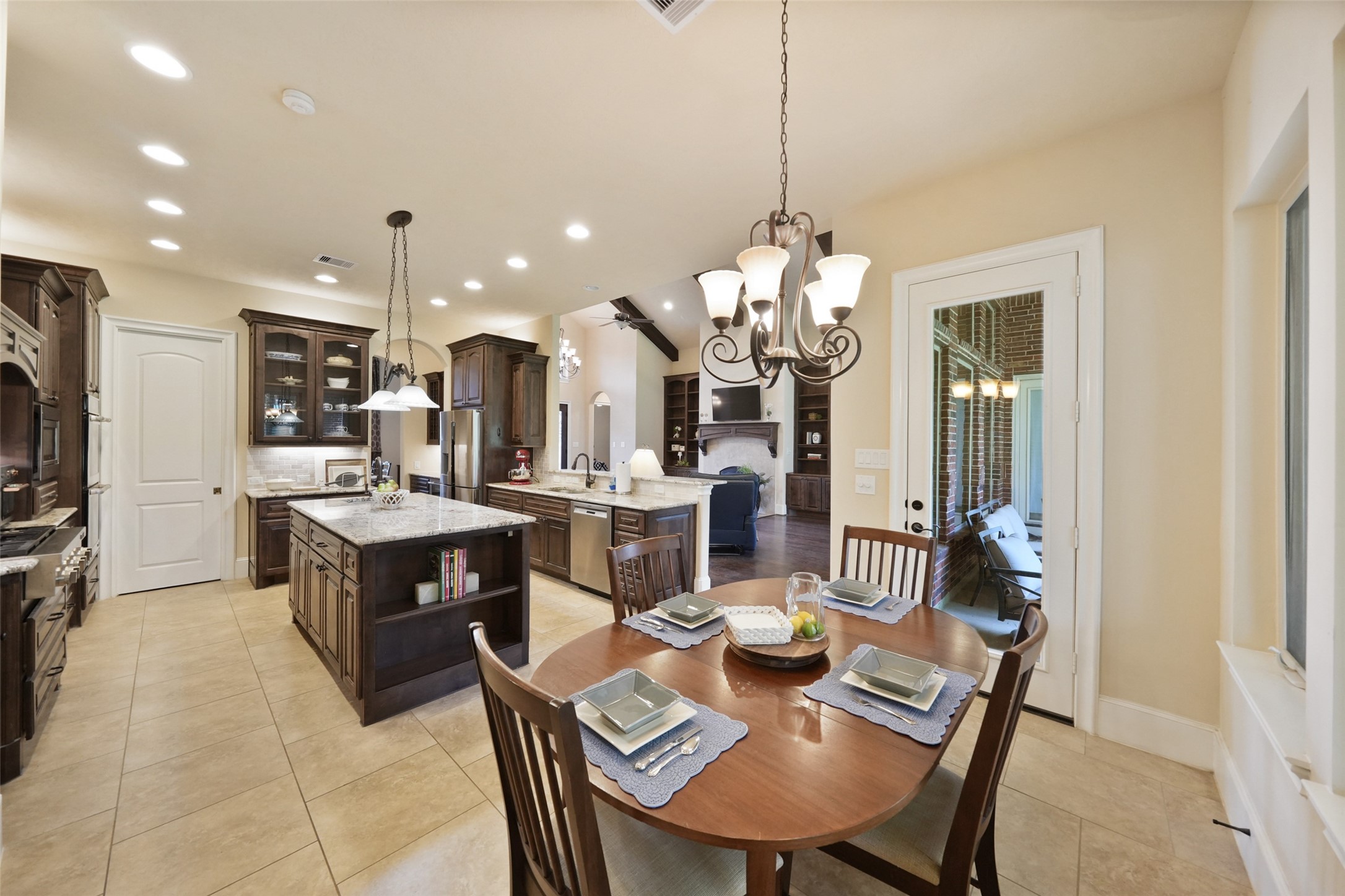 26250 A Riley Road Waller, TX 77484 - Photo 8 of 50 Sunny breakfast nook flows seamlessly into the kitchen, offering a casual dining option with backyard views through large windows.