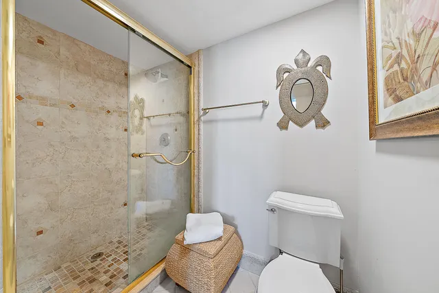 a bathroom with a toilet shower and sink