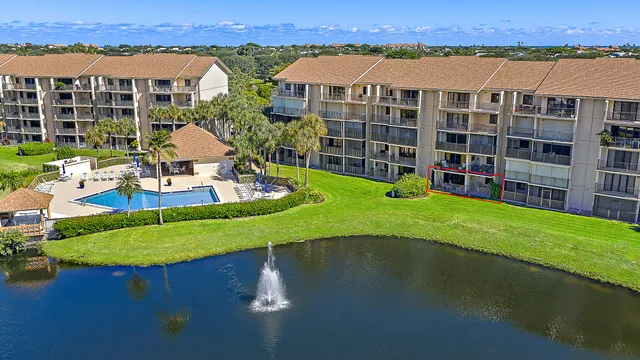 an aerial view of a house with a garden and lake view