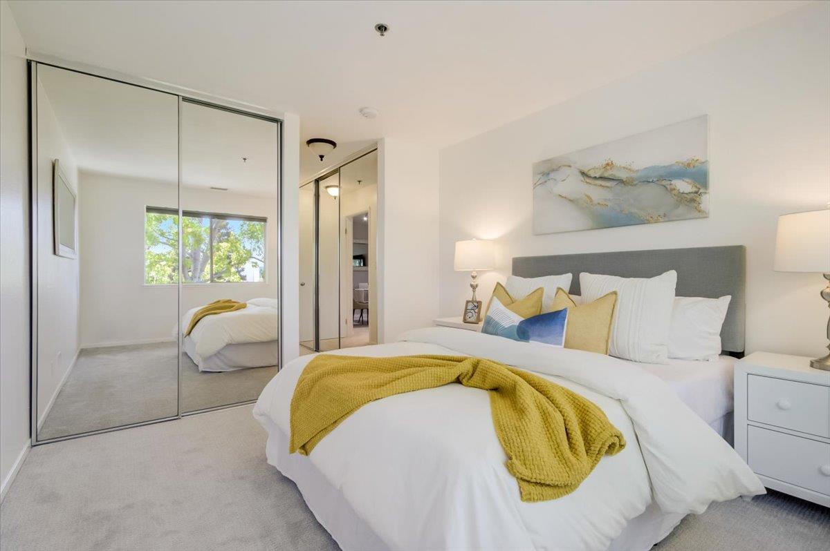 300 Murchison Drive, Unit 311 Millbrae, CA 94030 - Photo 13 of 25 a bedroom with a bed and glass walk in closet