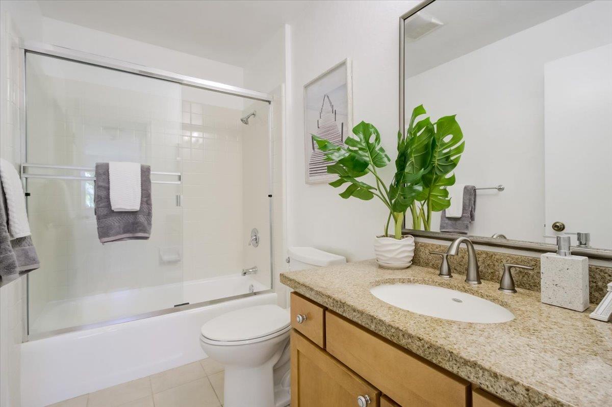 300 Murchison Drive, Unit 311 Millbrae, CA 94030 - Photo 14 of 25 a bathroom with a granite countertop sink a toilet and shower