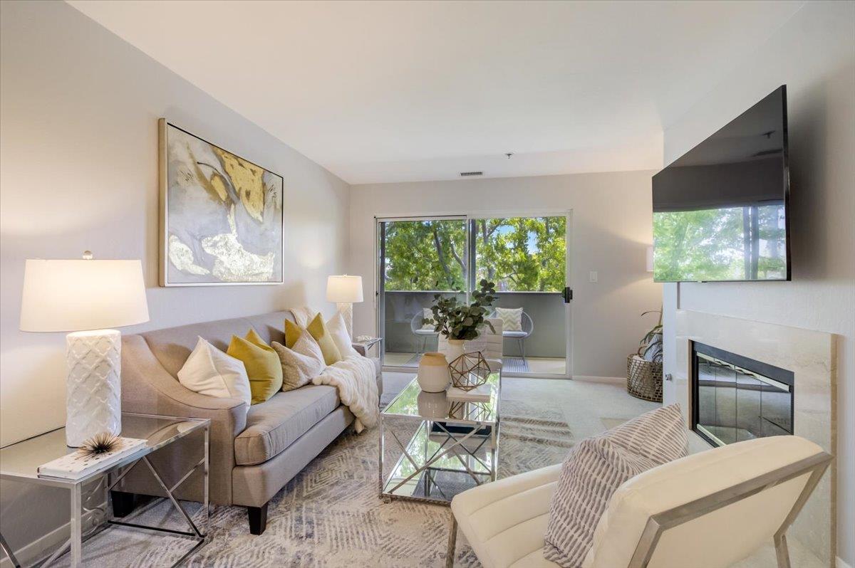 300 Murchison Drive, Unit 311 Millbrae, CA 94030 - Photo 2 of 25 a living room with furniture and a flat screen tv