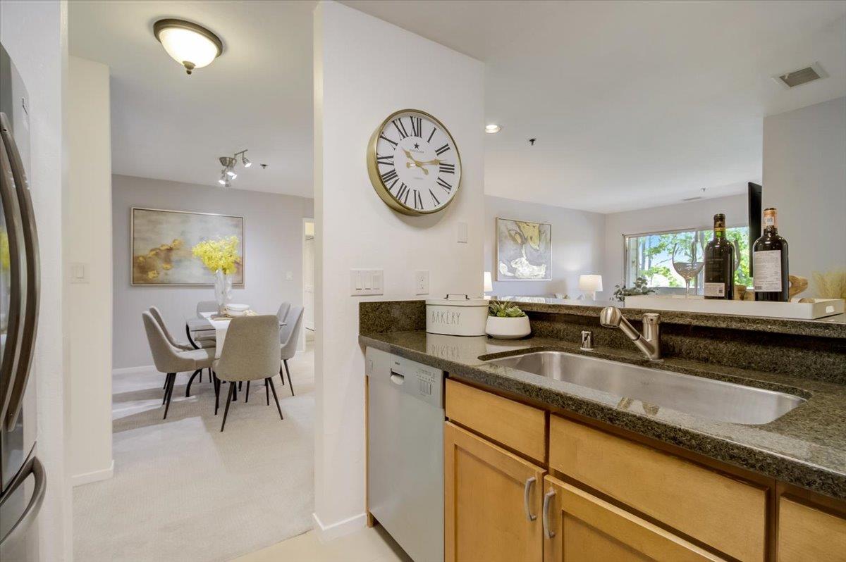 300 Murchison Drive, Unit 311 Millbrae, CA 94030 - Photo 6 of 25 a kitchen with a sink and a clock on the wall