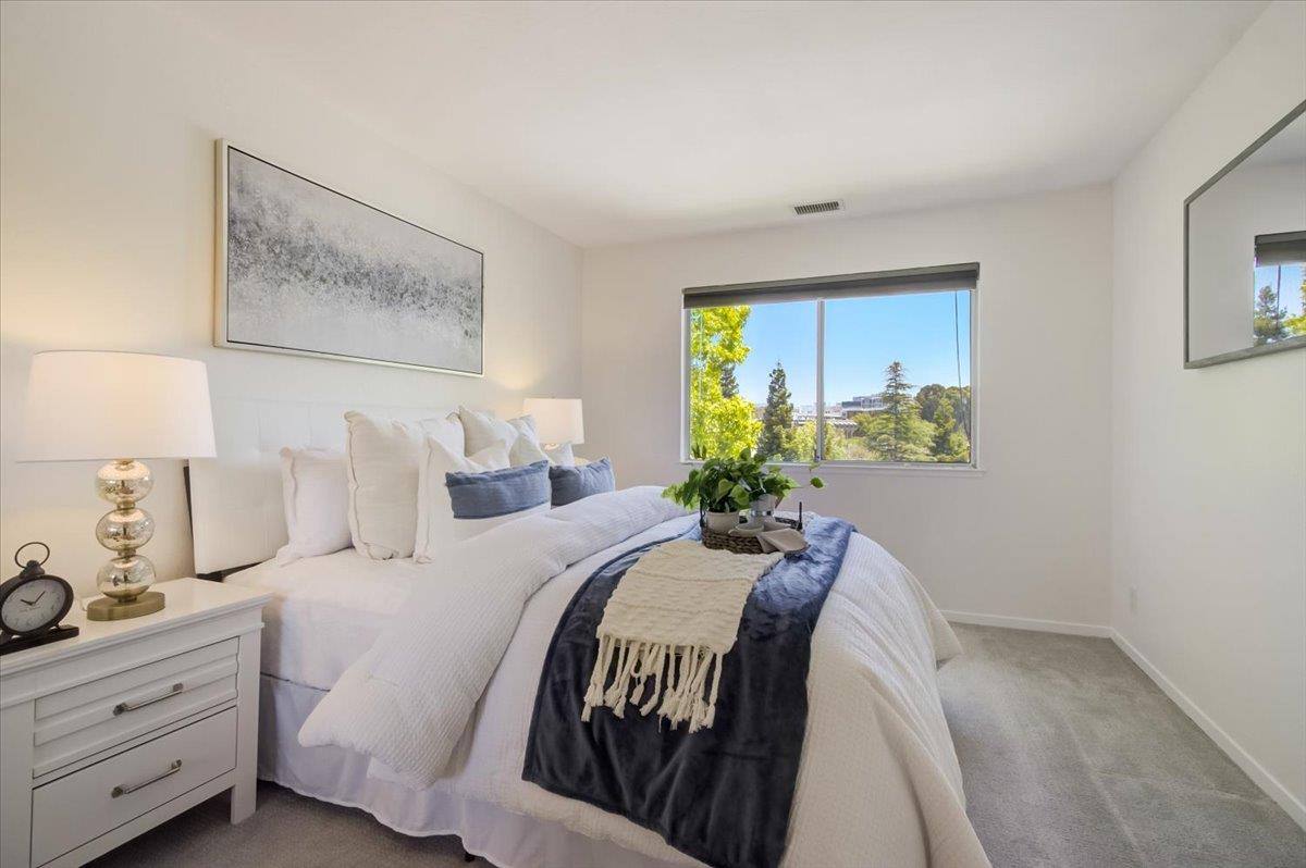 300 Murchison Drive, Unit 311 Millbrae, CA 94030 - Photo 10 of 25 a bedroom with a bed and a painting on the wall