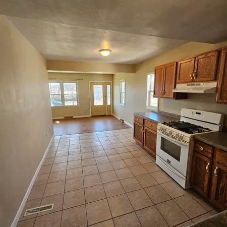 a kitchen with stainless steel appliances granite countertop a sink and cabinets