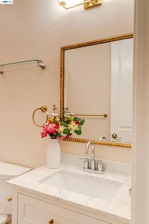 a bathroom with a toilet a sink and mirror