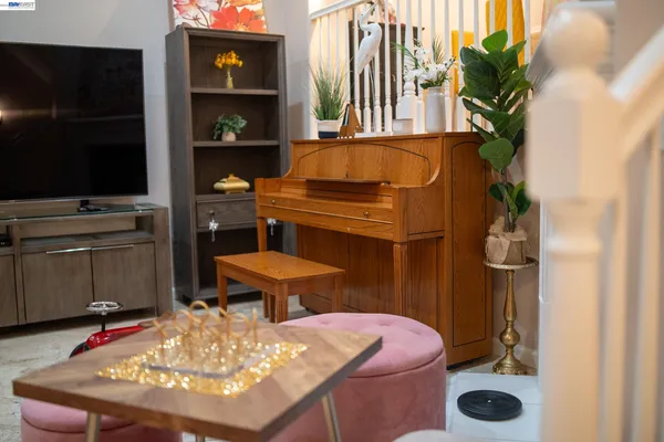 a living room with furniture a flat screen tv and a potted plant