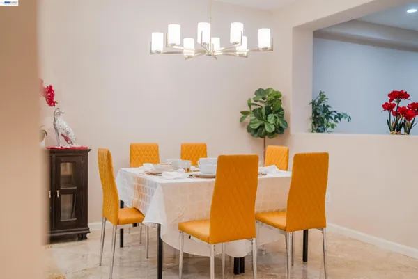 a view of a dining room with furniture and chandelier