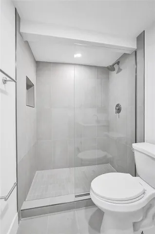 a bathroom with a toilet and a shower
