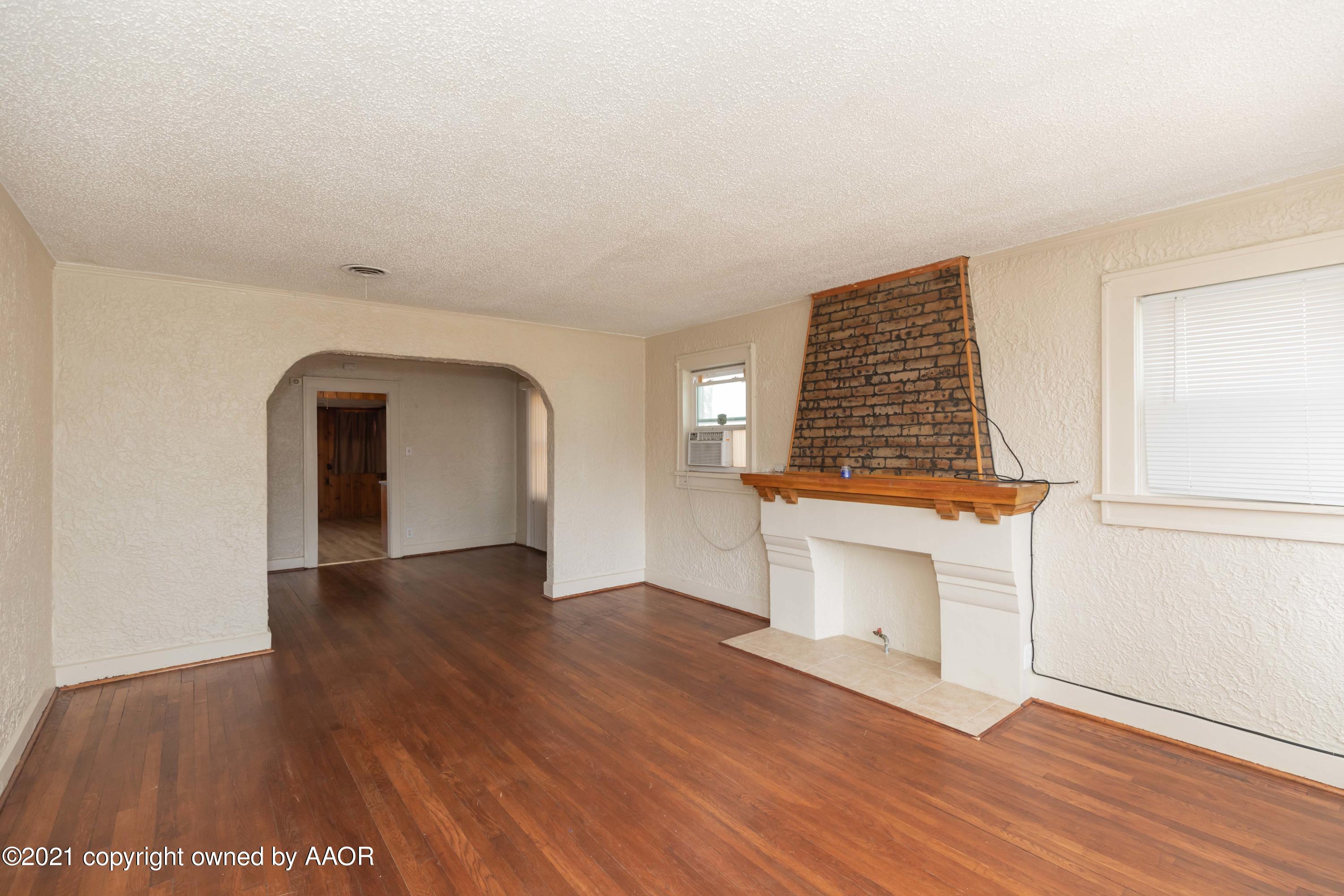 3804 South Tyler Street Amarillo, TX 79110 - Photo 3 of 17 wooden floor in an empty room with a window