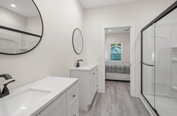 a bathroom with a sink a toilet and a mirror