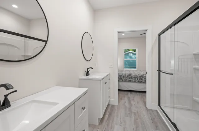 a bathroom with a sink a toilet and a mirror