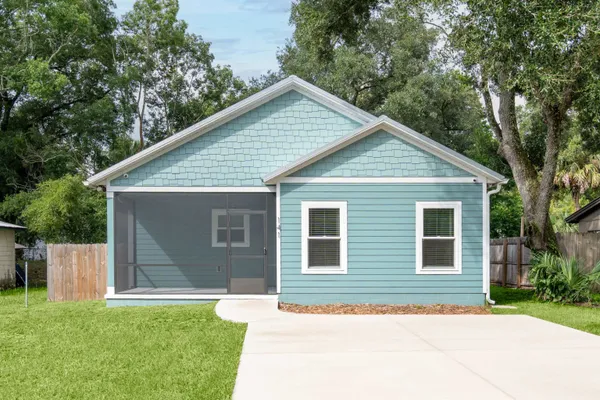 a front view of house with yard and green space