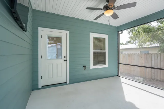 a view of a livingroom with a ceiling fan and window