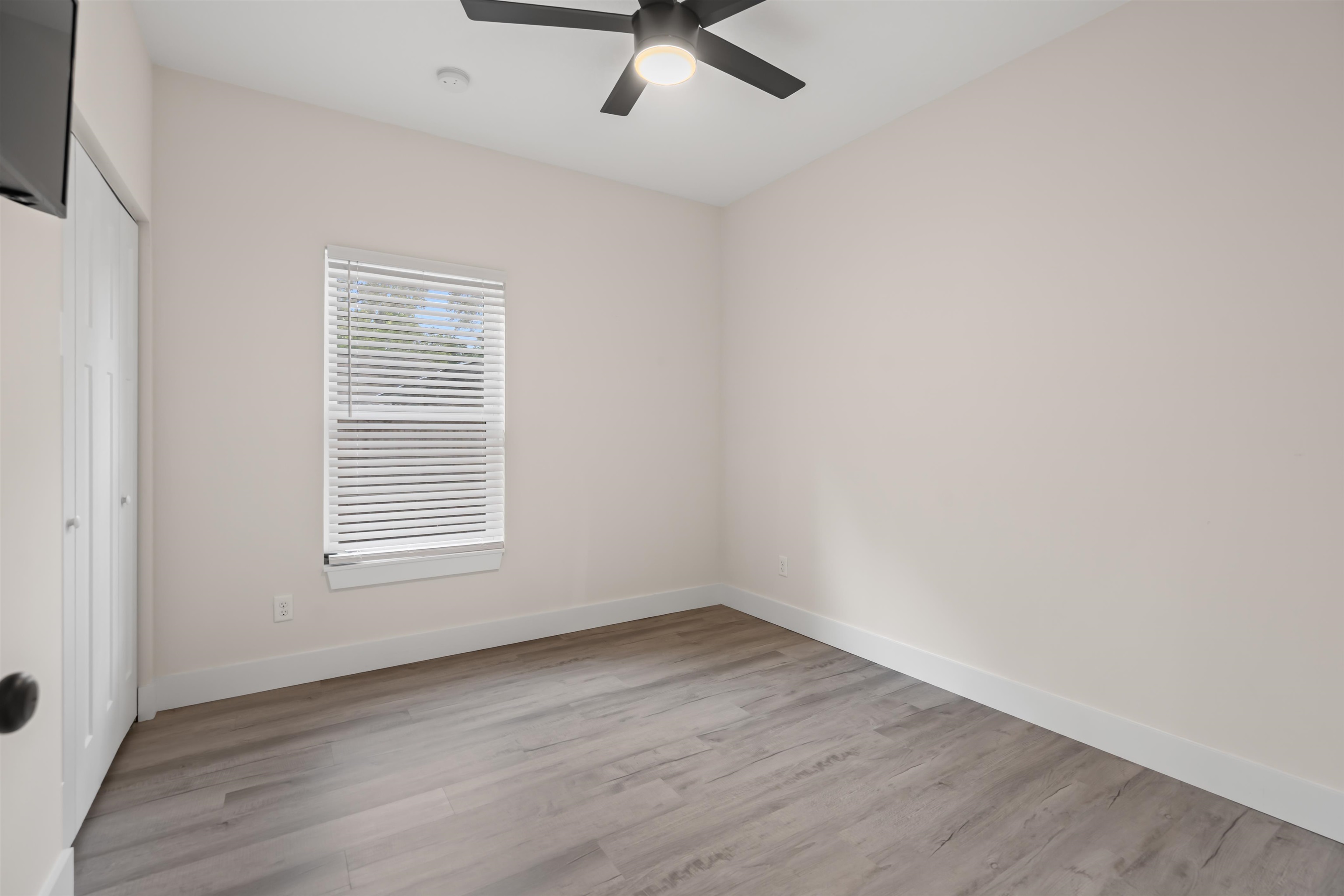 141 Webb Street St. Augustine, FL 32084 - Photo 22 of 33 an empty room with wooden floor fan and windows