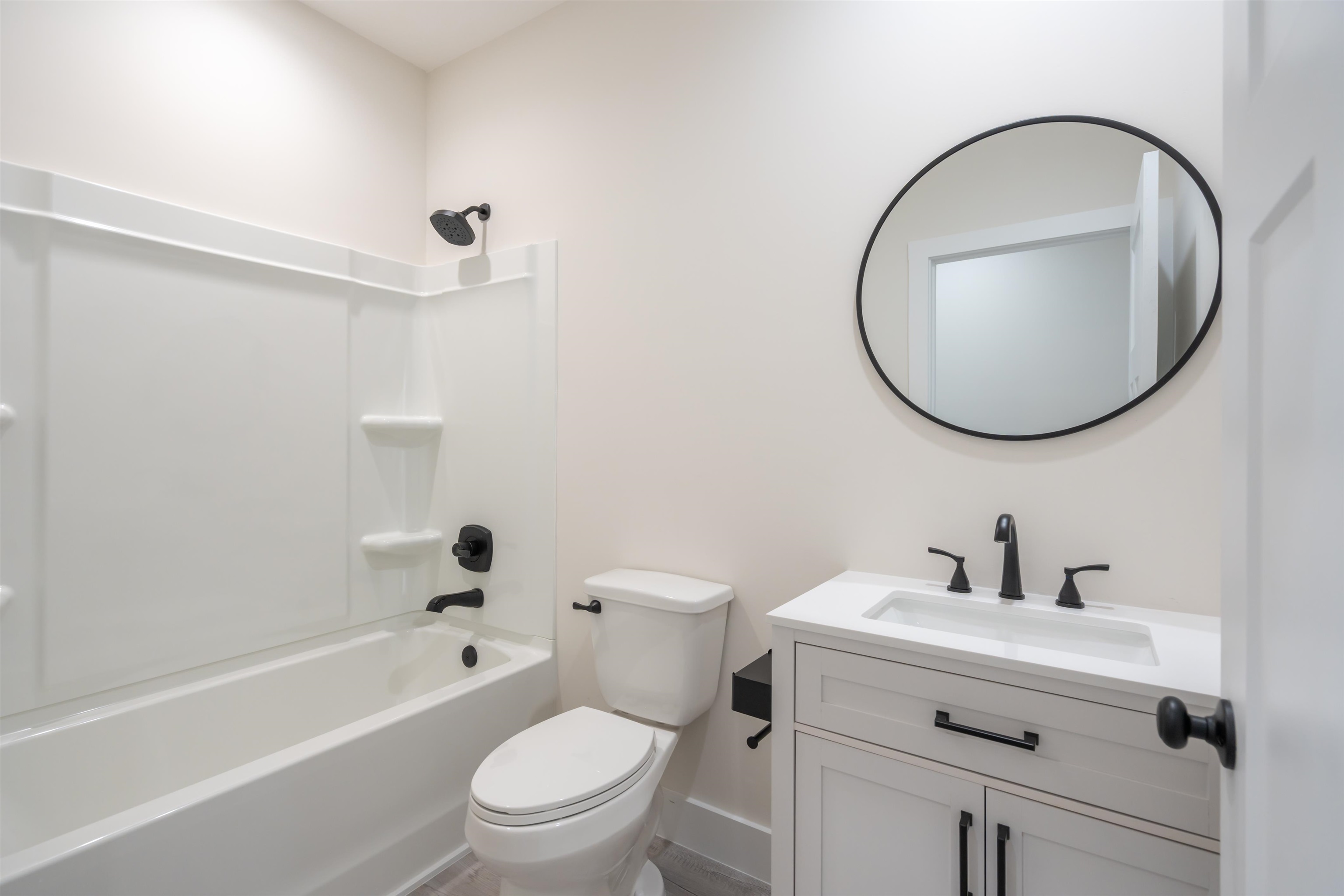 141 Webb Street St. Augustine, FL 32084 - Photo 24 of 33 a bathroom with a toilet a sink a mirror and tub