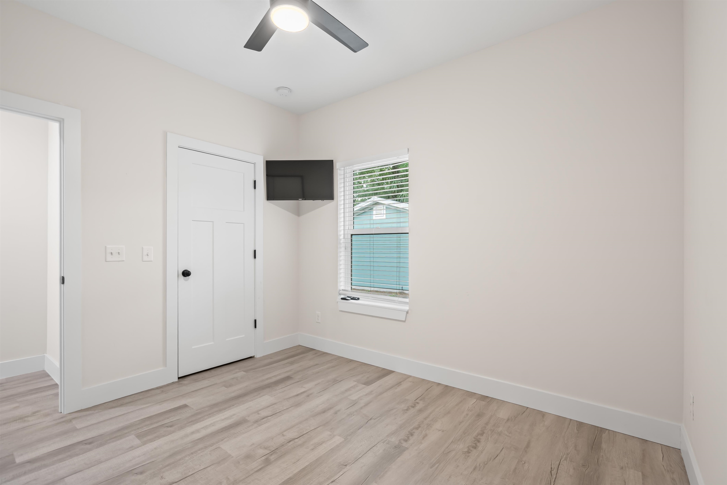 141 Webb Street St. Augustine, FL 32084 - Photo 26 of 33 an empty room with windows and ceiling fan