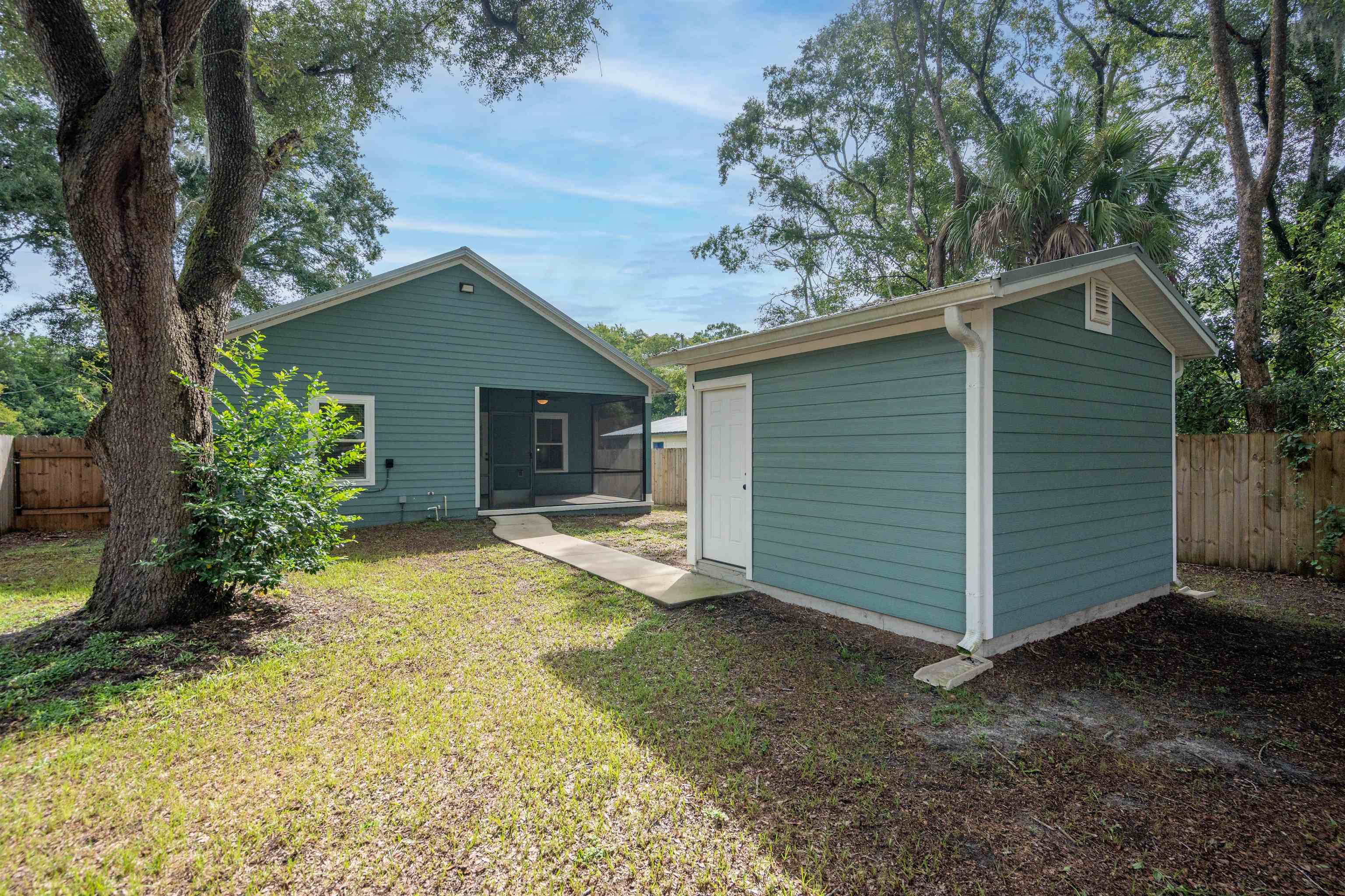 141 Webb Street St. Augustine, FL 32084 - Photo 30 of 33 a view of a house with a yard and garage