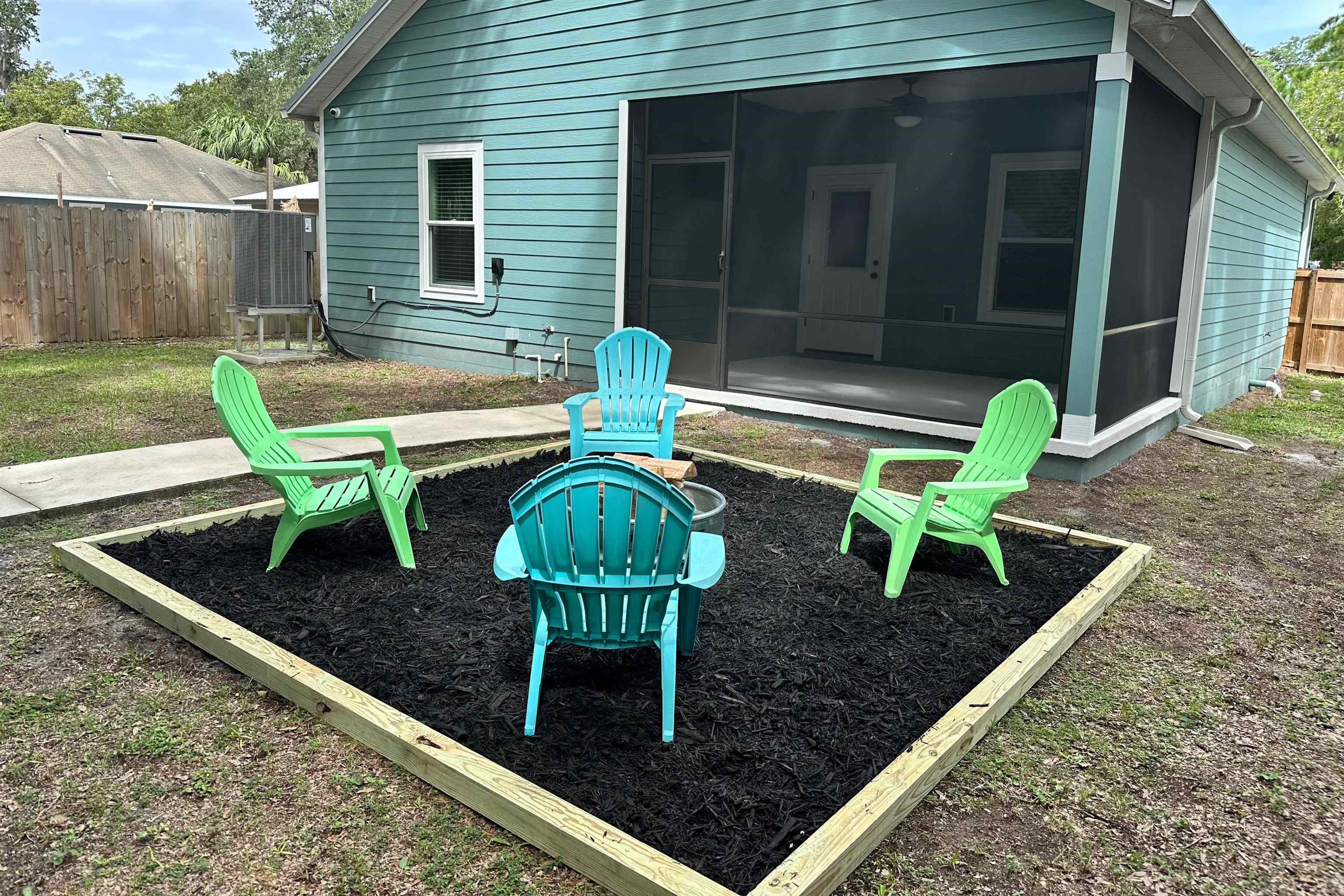 141 Webb Street St. Augustine, FL 32084 - Photo 31 of 33 a view of a chair and table in backyard of the house