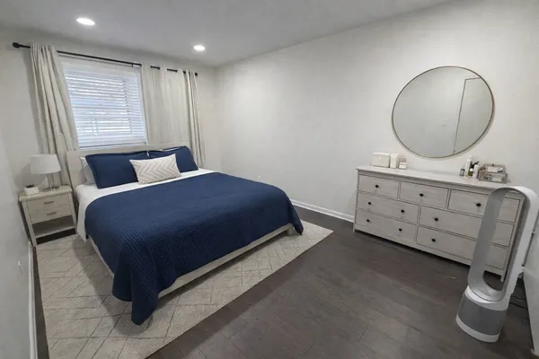 a bedroom with a large bed and a chandelier