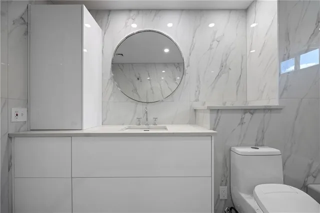 a view of a room with wooden floor and white walls