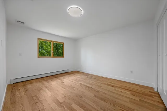 a view of room with wooden floor