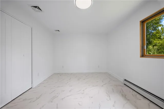 a view of room with window and ceiling fan