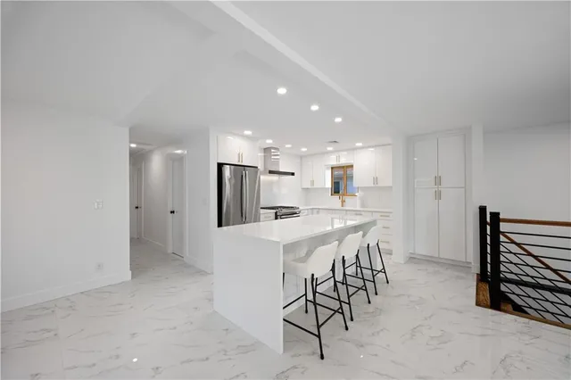 a view of kitchen with furniture and refrigerator