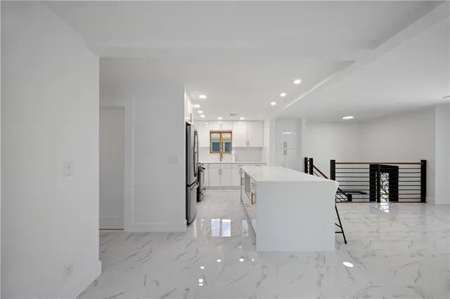 a kitchen with stainless steel appliances a refrigerator and a sink
