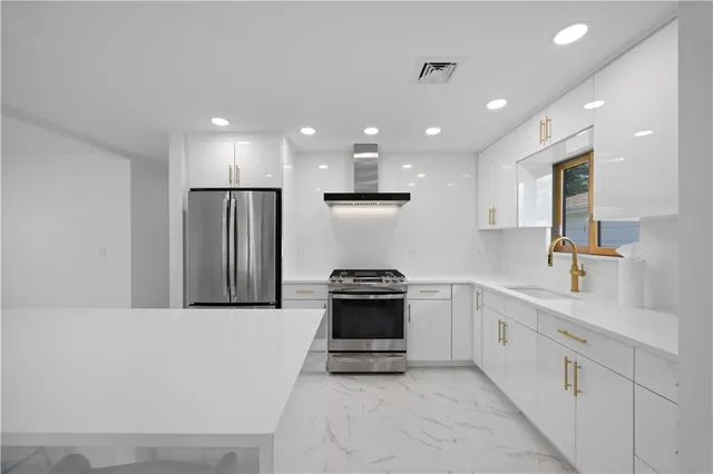 a kitchen with stainless steel appliances kitchen island granite countertop a stove a refrigerator a oven a sink with a dining table and chairs