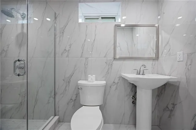 a bathroom with a sink toilet and a mirror