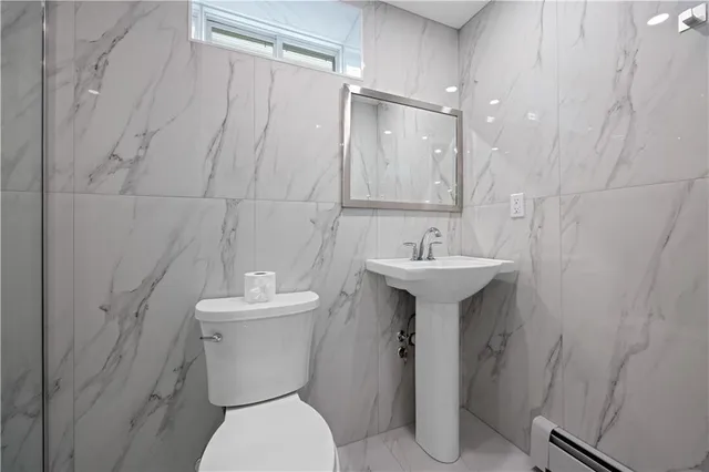 a bathroom with a shower a toilet and sink