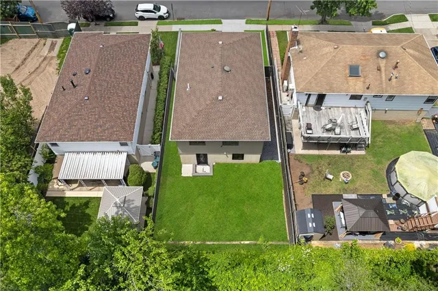 an aerial view of residential house with outdoor space and a swimming pool